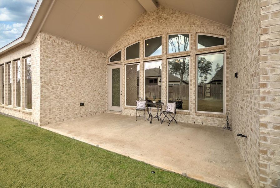 This spacious 18' x 10' covered patio comes equipped with a gas line for a future outdoor kitchen and convenient electrical outlets, making it ideal for creating a personalized outdoor entertainment area.