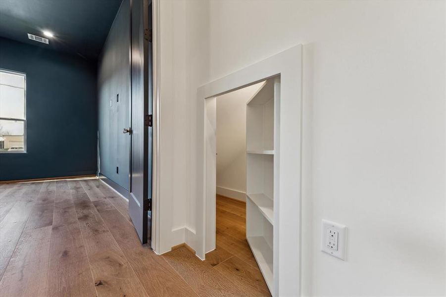 Hidden and cute shelf door to under stairs storage.