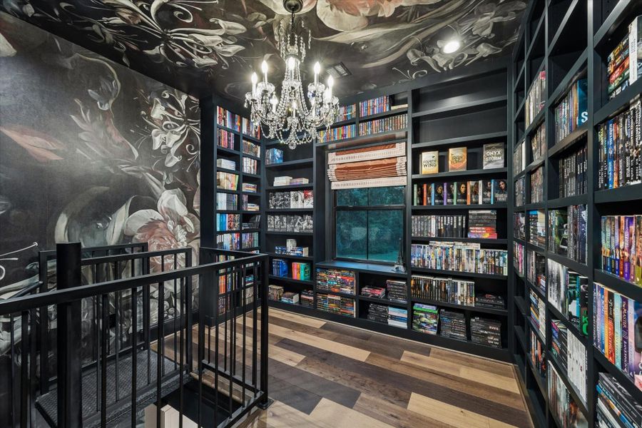 This remarkable library is a true statement space, where custom adjustable shelving, dramatic designer wallpaper, and artisan craftsmanship create an extraordinary setting for treasured collections, and quiet reading.