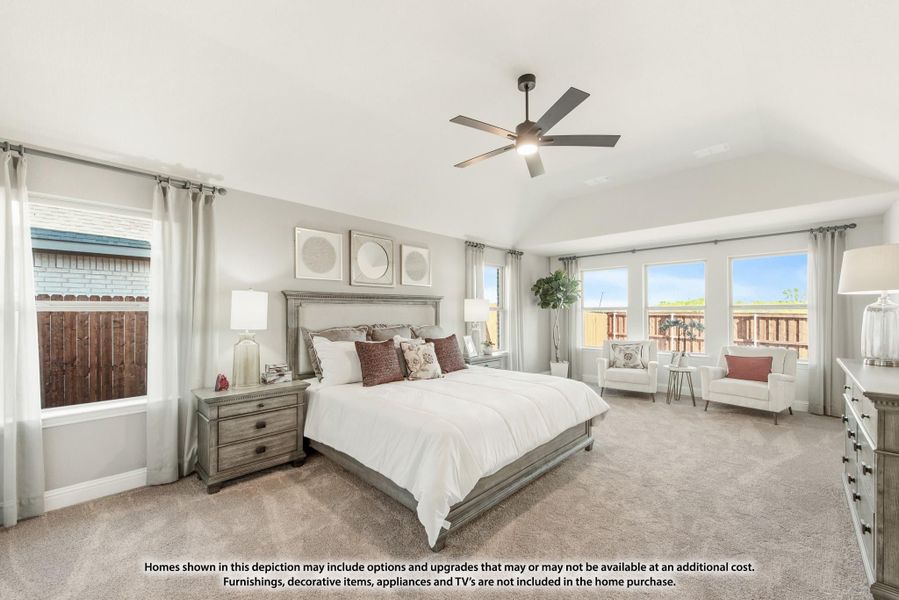 Spacious master bedroom with vaulted ceiling, ceiling fan, carpet flooring, and multiple windows Spacious master bedroom with vaulted ceiling, ceiling fan, carpet flooring, and multiple windows