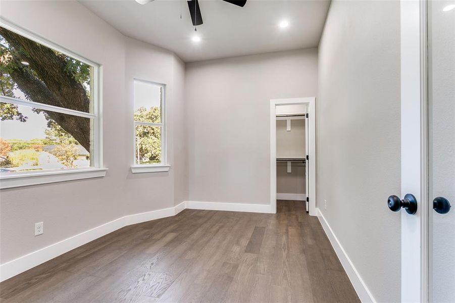 Spare room featuring dark wood-style floors, ceiling fan, and recessed lighting