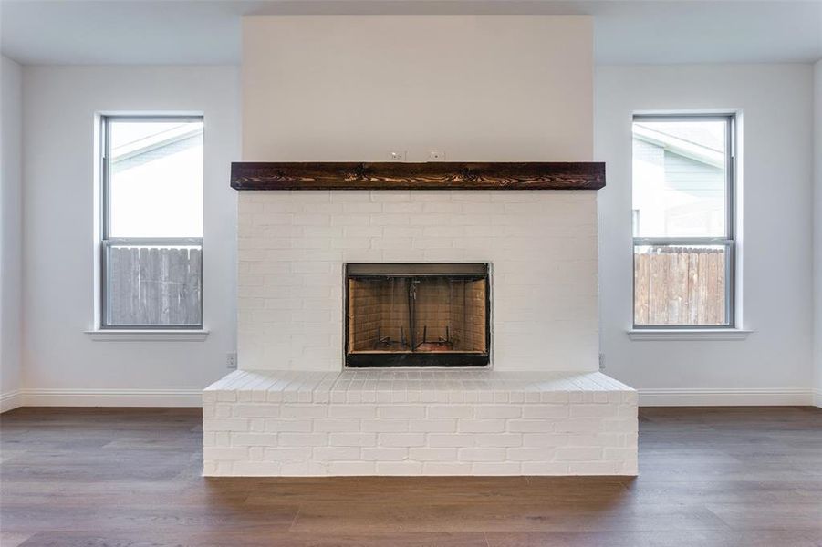 Details with hardwood / wood-style floors and a fireplace