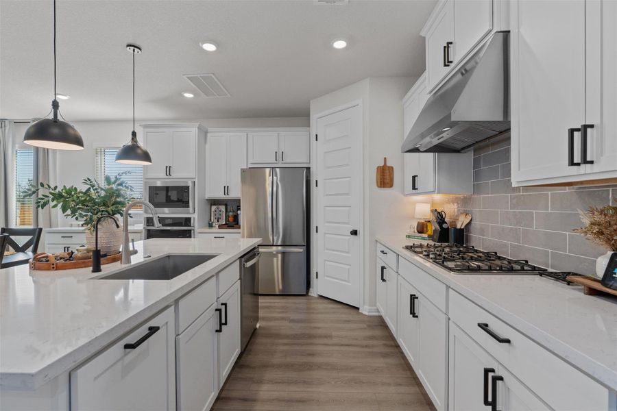 Kitchen featuring white cabinetry and stainless steel appliances