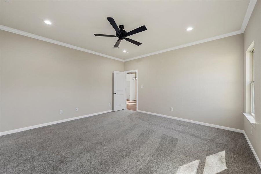 Carpeted spare room featuring ceiling fan, crown molding, and recessed lighting