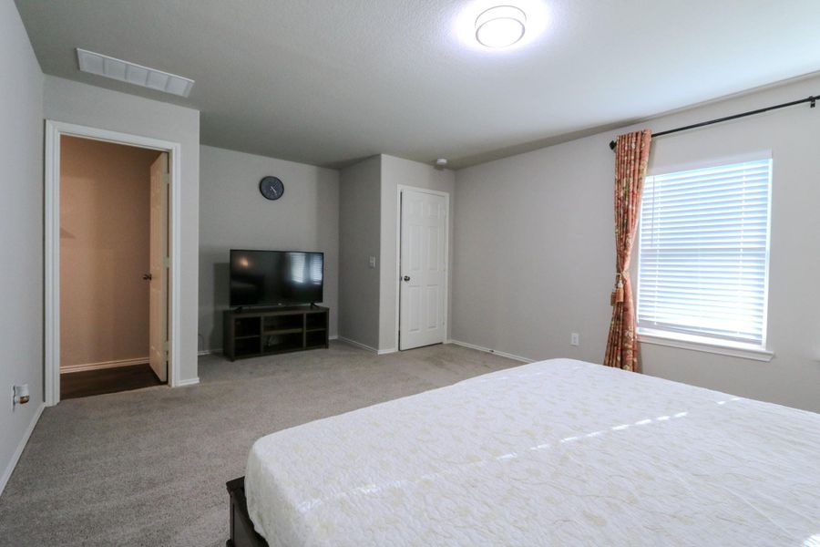 Primary bedroom with entertainment center. Primary bedroom with entertainment center.