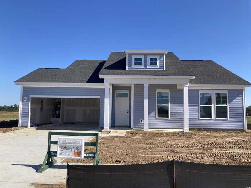 View of front facade featuring covered porch, concrete driveway, a shingled roof, and an attached garage View of front facade featuring covered porch, concrete driveway, a shingled roof, and an attached garage
