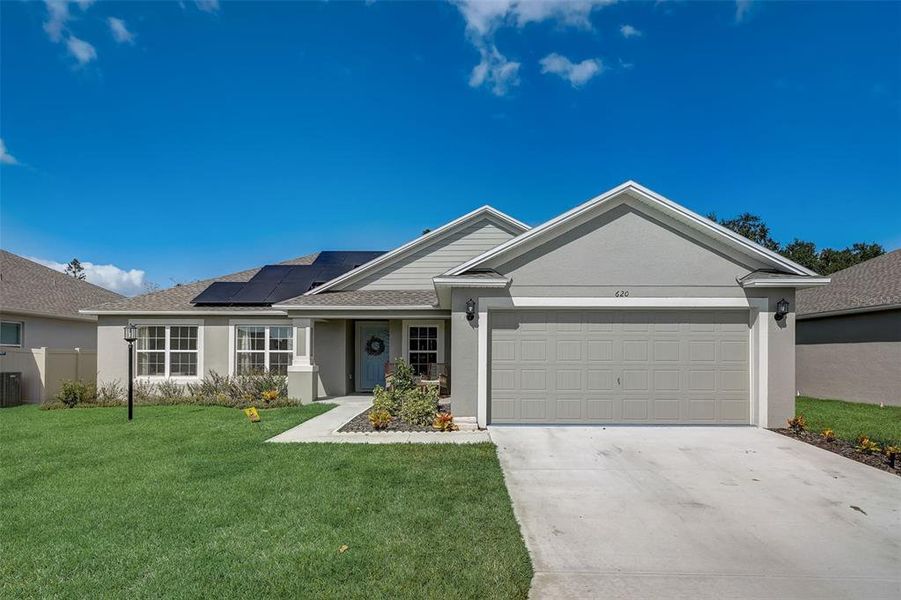 Front exterior of a new home in The Grove At Crystal Beach, Winter Haven, FL, highlighting curb appeal (Image 18). Front exterior of a new home in The Grove At Crystal Beach, Winter Haven, FL, highlighting curb appeal (Image 18).