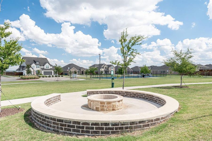 Surrounding community with a yard and an outdoor fire pit