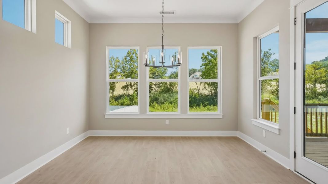 Dining area with various windows next to backyard door