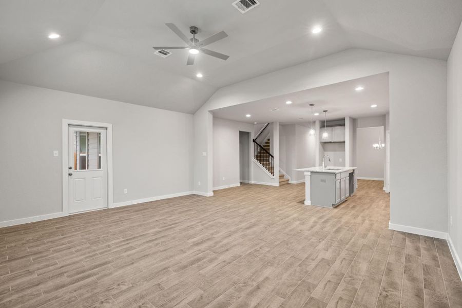 Take another glimpse into the heart of the home with this additional view of the family room—a sprawling space ready to accommodate all your gatherings. Sample photo of completed home with similar floor plan. As-built interior colors and selections may vary.