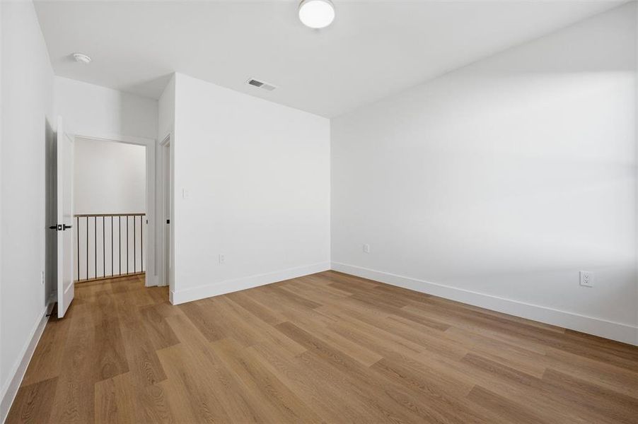 Secondary Bedroom features flush-mount lighting. Window provides natural light throughout the room. Vinyl flooring extends throughout.