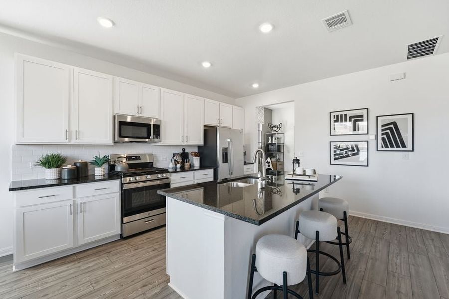 Representative furnished interior of a home built from the Harrier by Taylor Morrison in Longview 40s, Del Valle (Image 4).