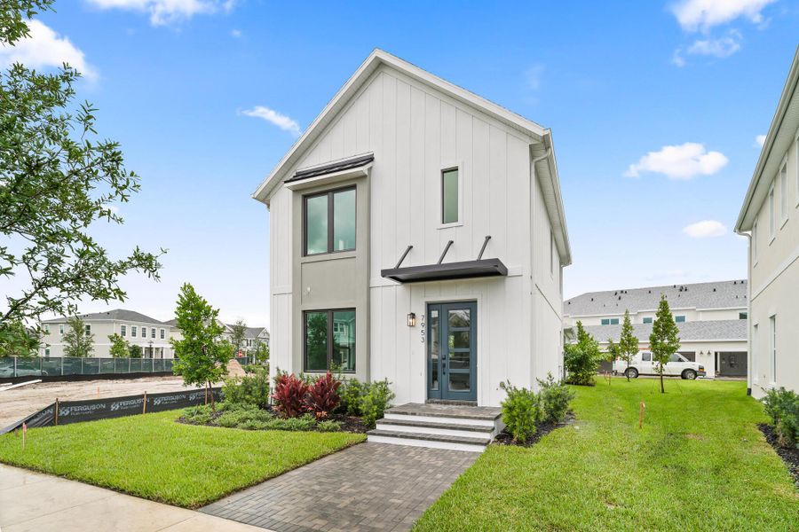 Front exterior of a new home in Newfield - Rosette Park, Palm City, FL, highlighting curb appeal (Image 13).