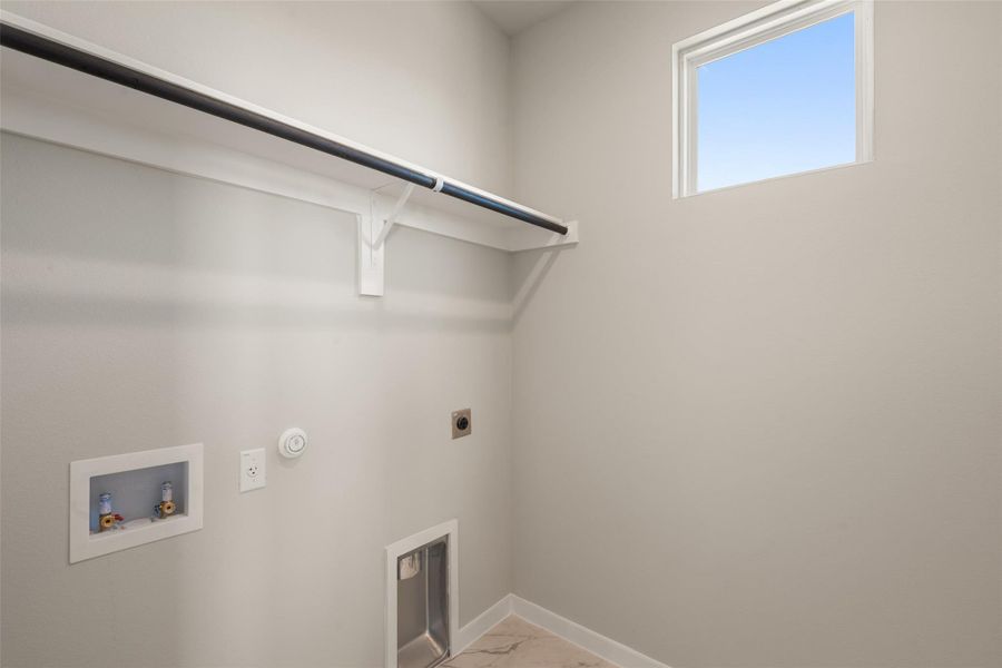 Washroom featuring hookup for a washing machine, gas dryer hookup, electric dryer hookup, and light marble finish floors