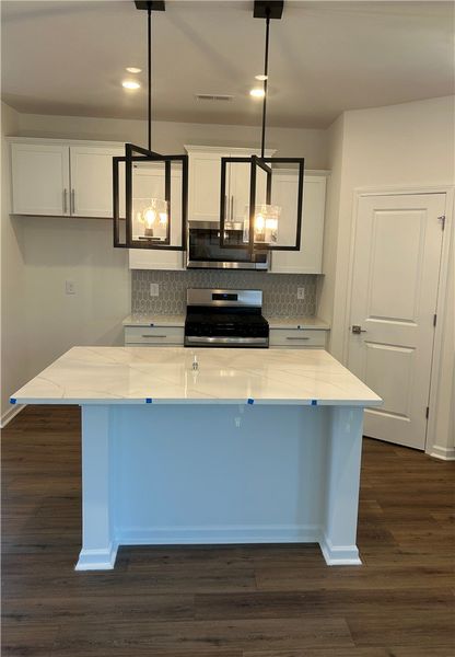 This bright kitchen features a functional island,