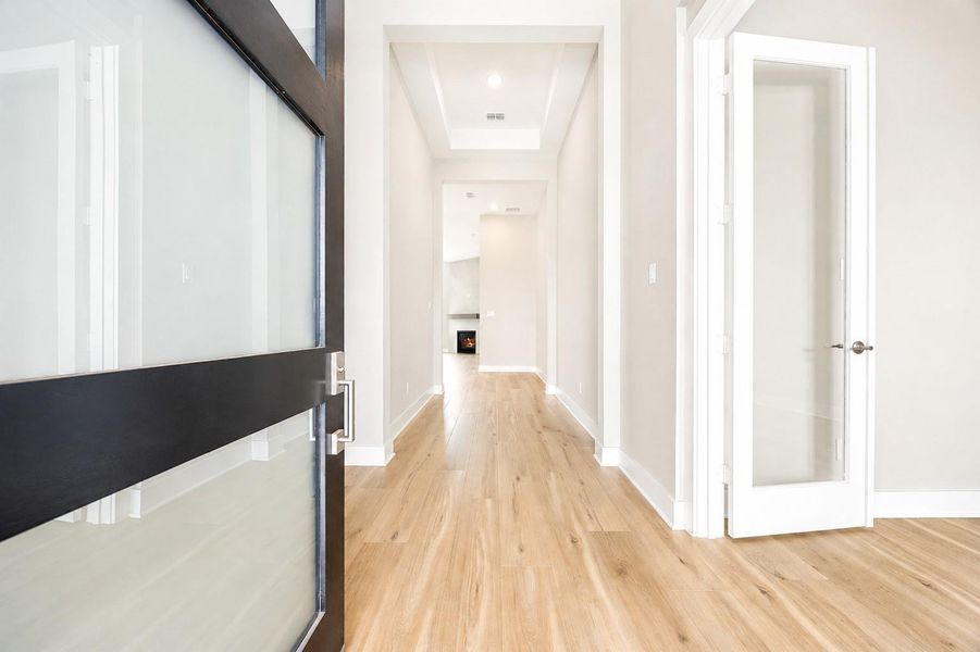 A bright entry foyer with wide-plank flooring welcomes you inside, with a private home office just off the entrance, ideal for remote work or a quiet study space. A bright entry foyer with wide-plank flooring welcomes you inside, with a private home office just off the entrance, ideal for remote work or a quiet study space.