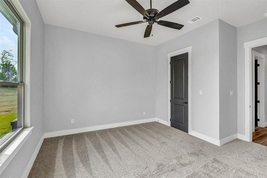 Spare room with ceiling fan and carpet floors