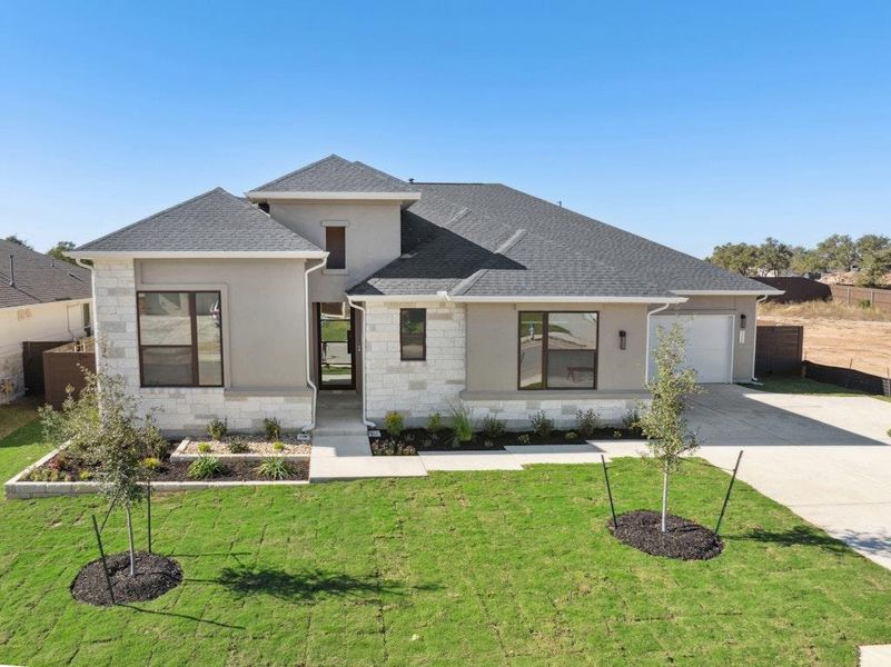 Front exterior of a new home in Riverstone, Georgetown, TX, highlighting curb appeal (Image 2). Front exterior of a new home in Riverstone, Georgetown, TX, highlighting curb appeal (Image 2).