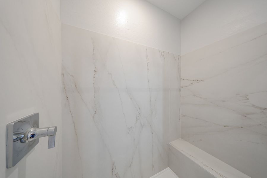 A white wall with a silver door.