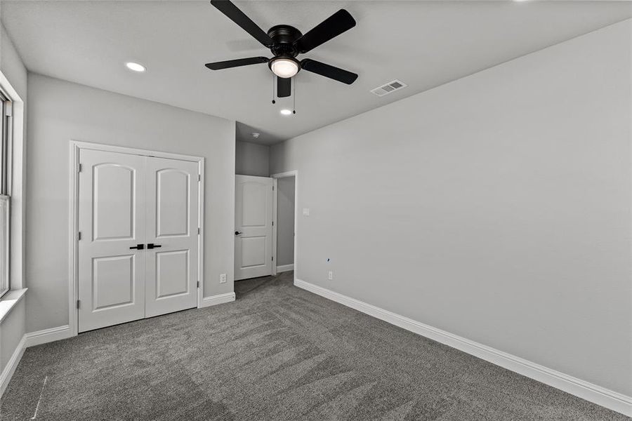 Unfurnished bedroom with carpet floors, recessed lighting, a closet, and a ceiling fan Unfurnished bedroom with carpet floors, recessed lighting, a closet, and a ceiling fan