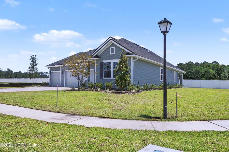 Front exterior of a new home in Brookestone, St. Augustine, FL, highlighting curb appeal (Image 1). Front exterior of a new home in Brookestone, St. Augustine, FL, highlighting curb appeal (Image 1).