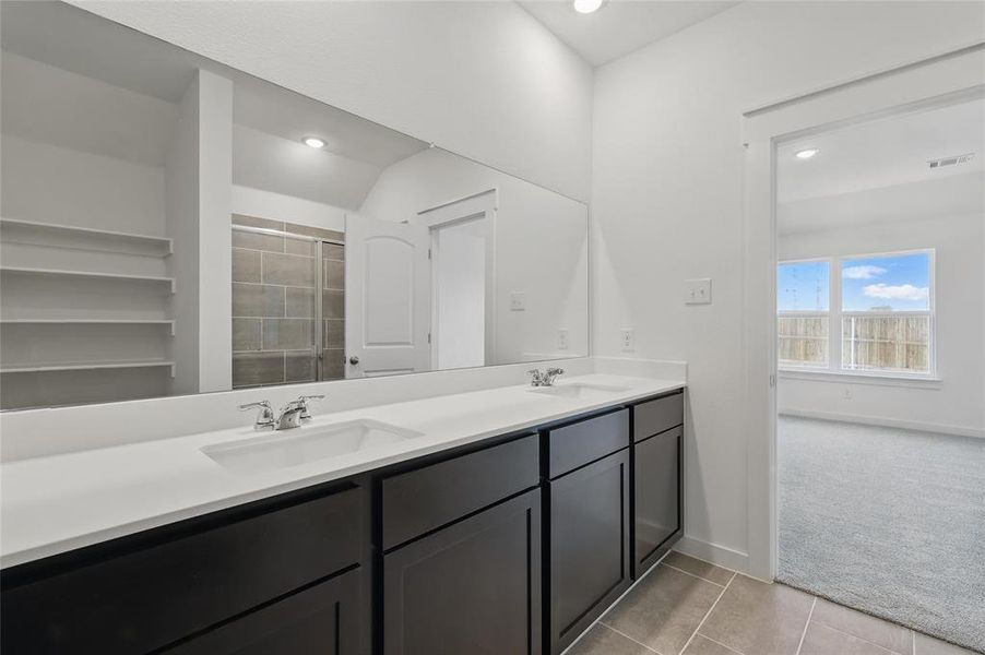 Bathroom with a sink, visible vents, double vanity, and recessed lighting Bathroom with a sink, visible vents, double vanity, and recessed lighting