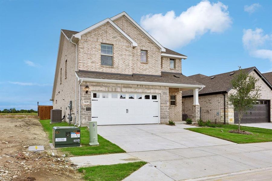 Front exterior of a new home in Parks at Foster Crossing - Spring Series, Anna, TX, highlighting curb appeal (Image 25). Front exterior of a new home in Parks at Foster Crossing - Spring Series, Anna, TX, highlighting curb appeal (Image 25).