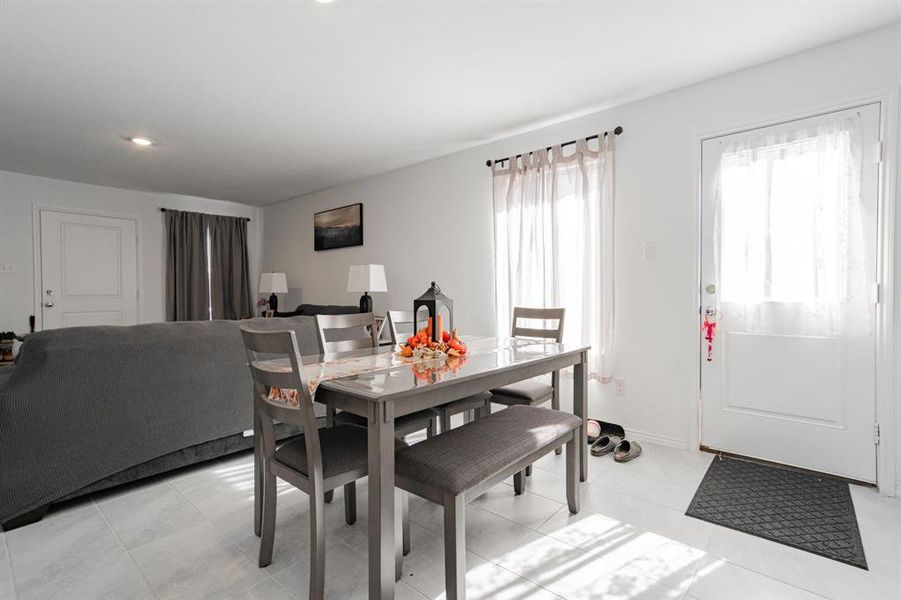 Dining room featuring recessed lighting and light tile patterned floors