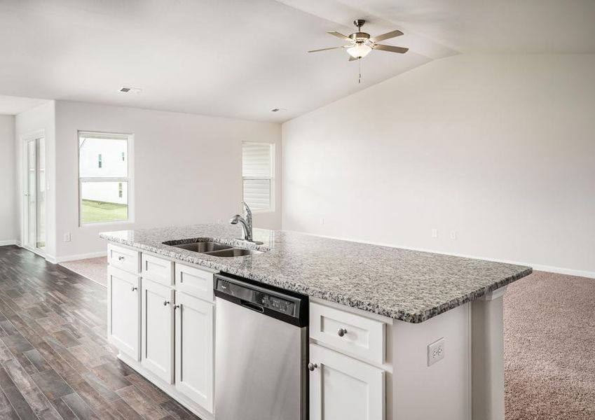 Kitchen with large granite island overlooking the spacious family room.