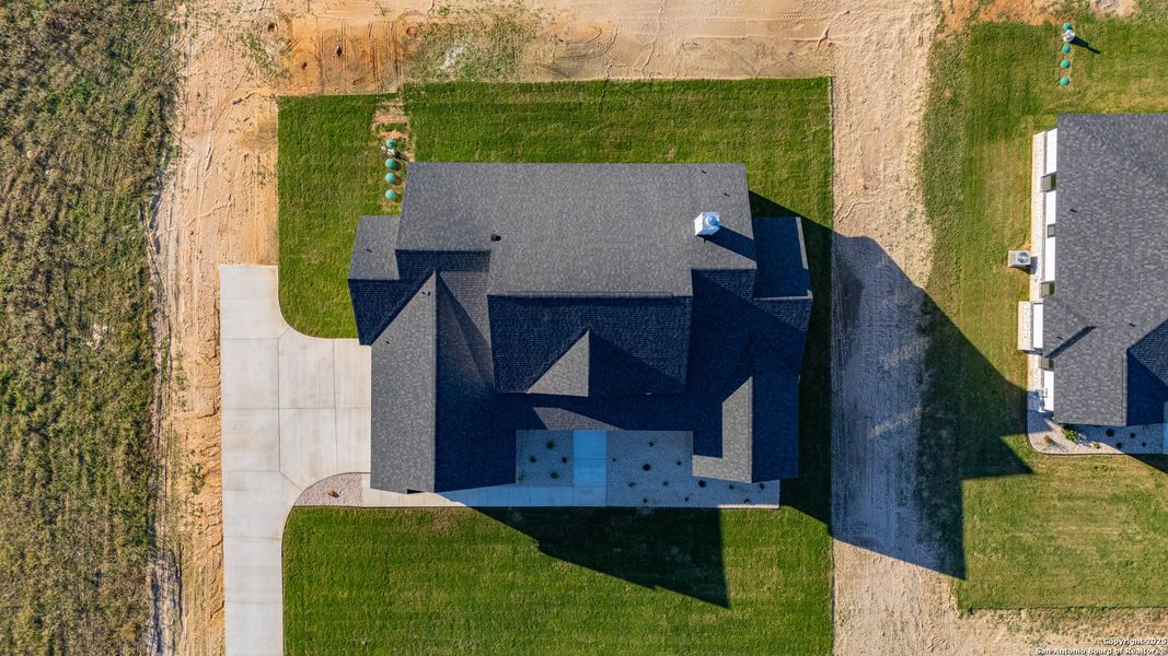 Front exterior of a new home in , La Vernia, TX, highlighting curb appeal (Image 26).