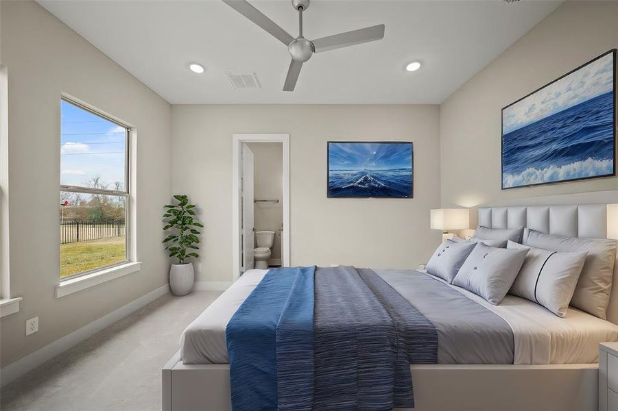 Virtually Staged: This secondary bedroom is located on the first floor. It features carpet floors, recessed lighting, a ceiling fan, and its own private bathroom.