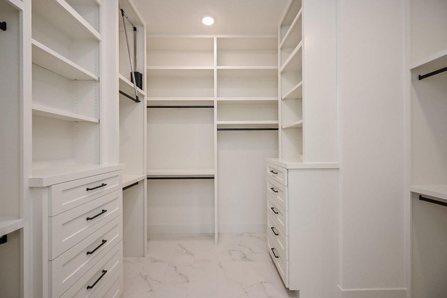 Master Closet with Tons of custom built ins, pull downs, and extra space.