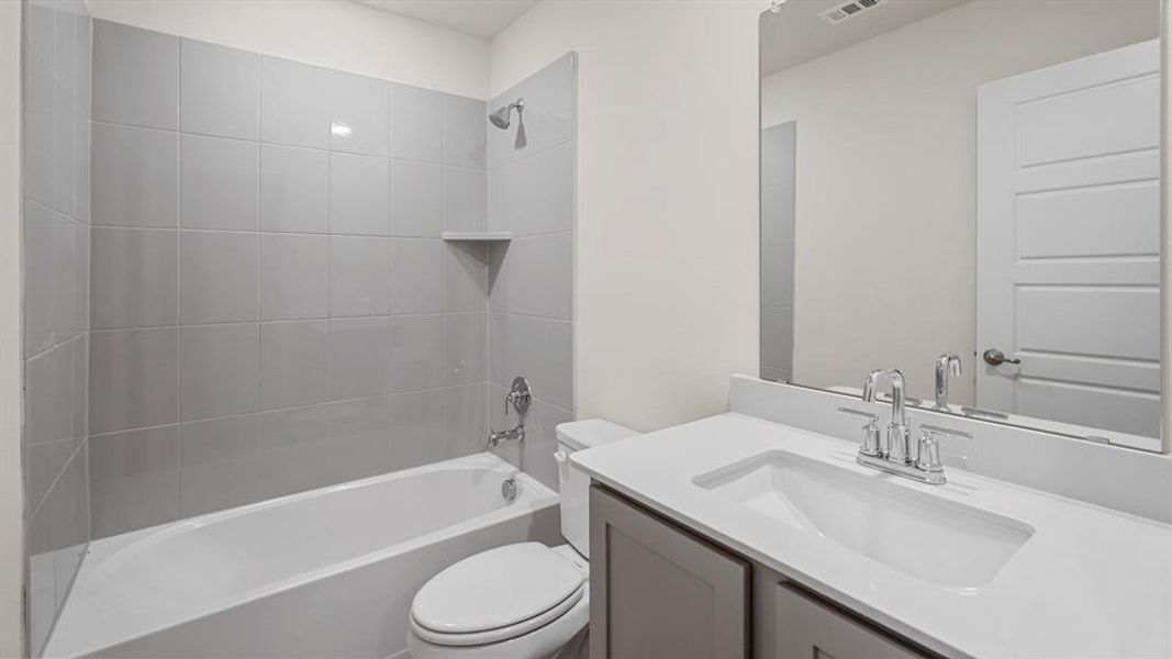 Bathroom featuring bathtub / shower combination and vanity Bathroom featuring bathtub / shower combination and vanity