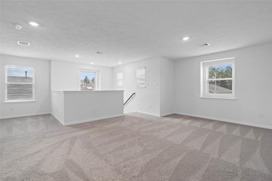 Come upstairs to the second floor with a game room, primary suite,  secondary bedrooms and bathrooms.