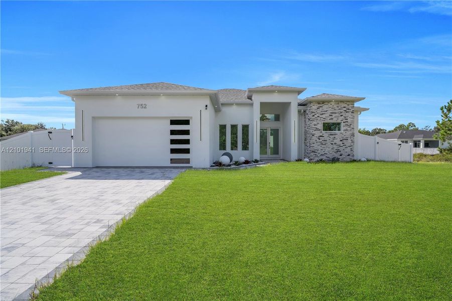 Front exterior of a new home in , Lehigh Acres, FL, highlighting curb appeal (Image 20).