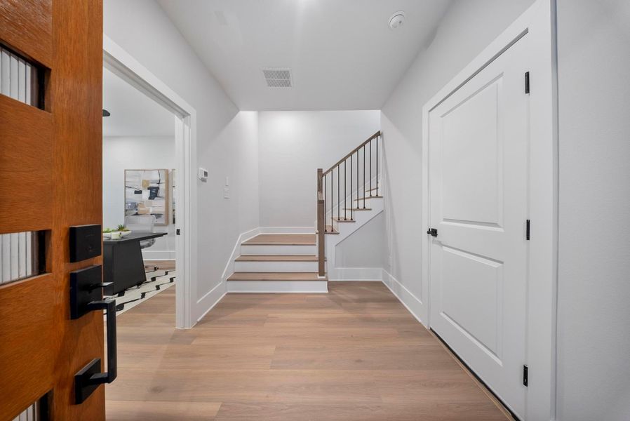 Welcome home to a bright and inviting entryway, featuring sleek hardwood floors and a seamless flow to the living areas.