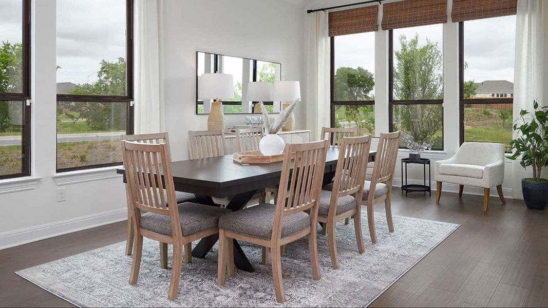 Dining area featuring baseboards and dark wood-style flooring Dining area featuring baseboards and dark wood-style flooring