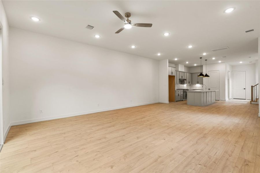 Seamless main floor flow — sprawling living zone leading directly into the chef's kitchen, perfect for effortless entertaining.