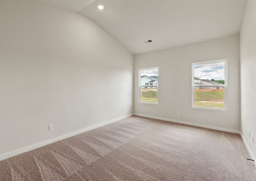 The master bedroom has lots of windows to let in natural light