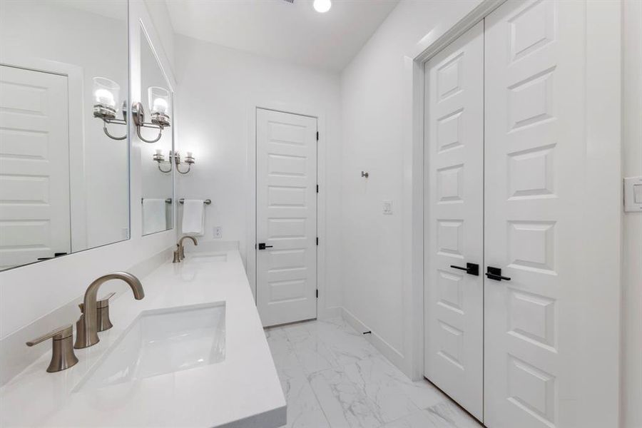 The bathroom is complete with dual sinks and a separate water closet, enhancing both functionality and privacy.