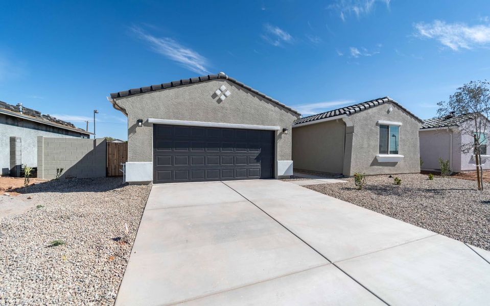 Front exterior of a new home in Rancho Mirage, Maricopa, AZ, highlighting curb appeal (Image 2). Front exterior of a new home in Rancho Mirage, Maricopa, AZ, highlighting curb appeal (Image 2).