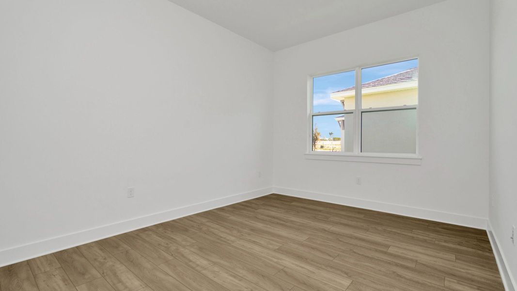 The Second Bedroom of a DRB Homes Grand Hawk which is offered as a home plan at Serengeti in Spring Hill, FL.