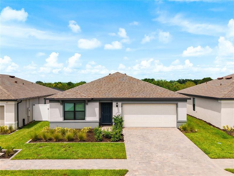 Front exterior of a new home in Caloosa Cove, Labelle, FL, highlighting curb appeal (Image 28).