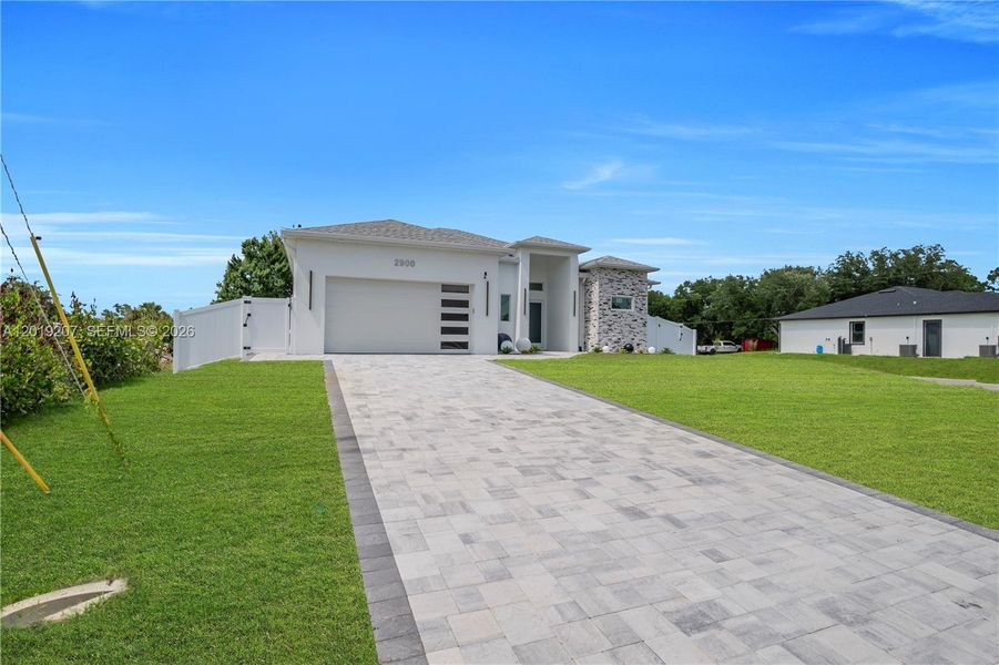 Front exterior of a new home in , Lehigh Acres, FL, highlighting curb appeal (Image 1). Front exterior of a new home in , Lehigh Acres, FL, highlighting curb appeal (Image 1).