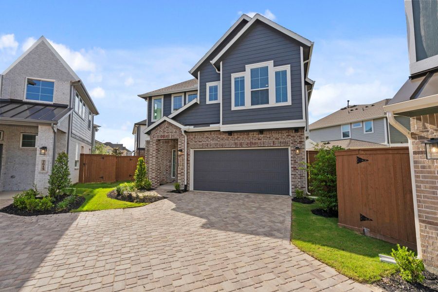 Front exterior of a new home in Elyson, Katy, TX, highlighting curb appeal (Image 20).