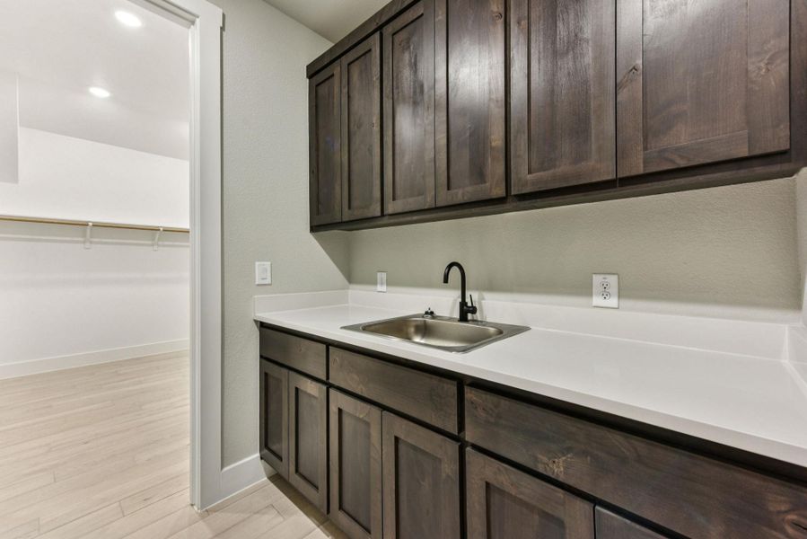 Laundry room featuring light wood-style flooring and recessed lighting