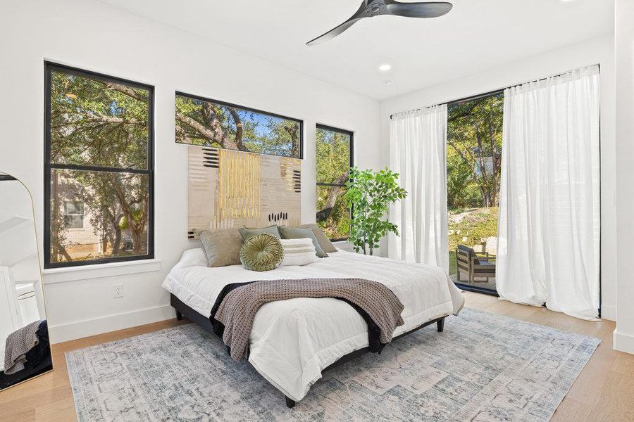 The main-level primary suite is your tranquil retreat wrapped in windows that infuse the space in natural light and frame scenic hill country views.