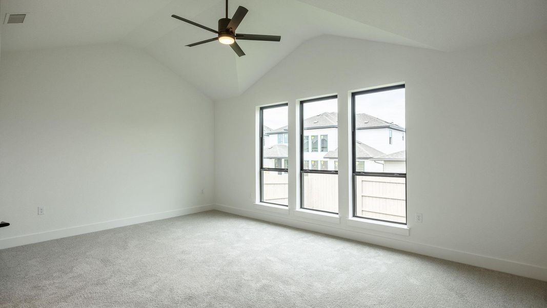 Bonus room with carpet floors, a ceiling fan, and lofted ceiling Bonus room with carpet floors, a ceiling fan, and lofted ceiling