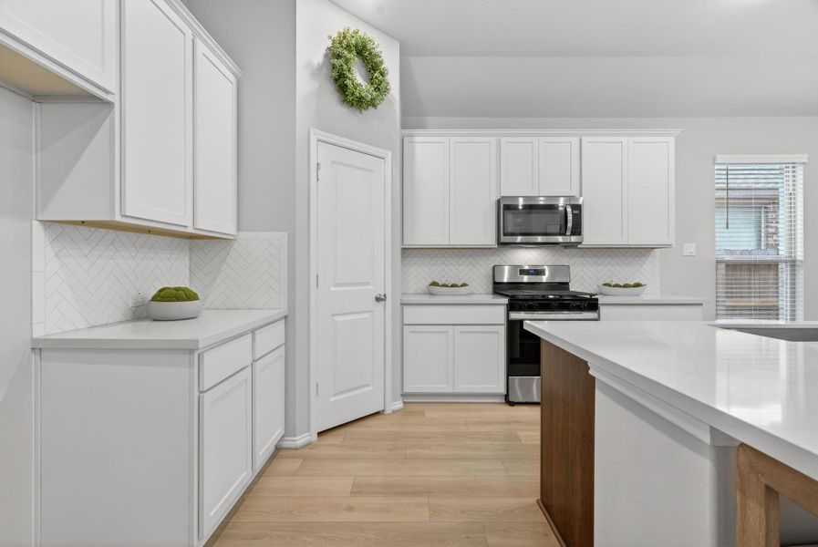 Another view of the kitchen looking towards the walk-in pantry. Another view of the kitchen looking towards the walk-in pantry.