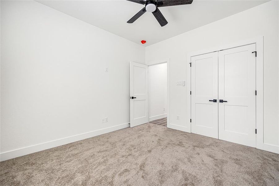 Comfortable Secondary BedroomThis inviting bedroom features a spacious double-door closet, plush carpeting, and a sleek ceiling fan. With a neutral color palette and natural light, this room offers a cozy and versatile space for any need!